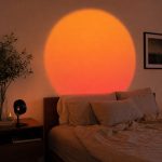 Sunset lamp glowing above a bed at night